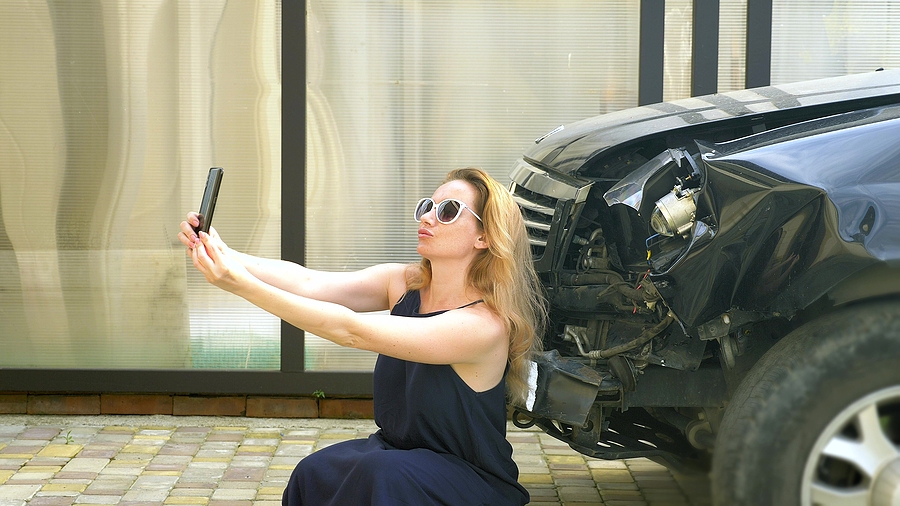 blonde lady taking selfie and posting about Car Accident